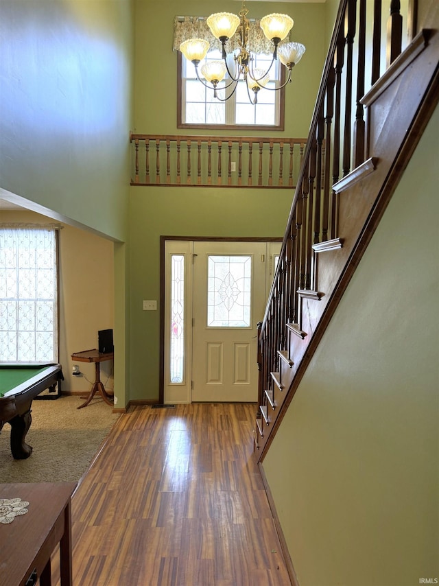 3020 10 Oclock Rd, Bloomingdale, IN 47832 - entrance foyer with healthy amount of natural light, a chandelier, stairs, wood finished floors, and a towering ceiling
