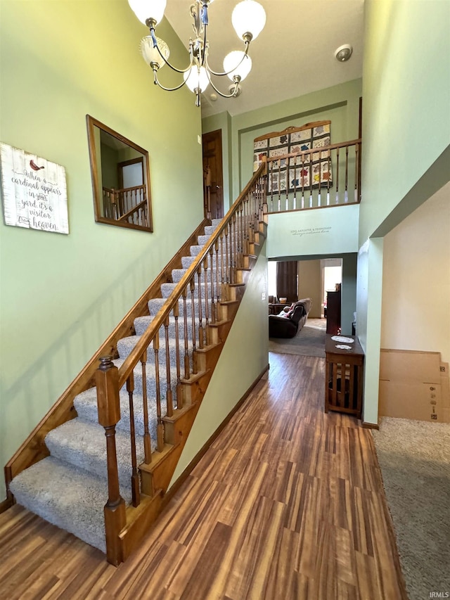 3020 10 Oclock Rd, Bloomingdale, IN 47832 - staircase with a chandelier, a towering ceiling, wood finished floors, and baseboards