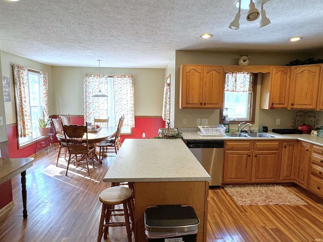 3020 10 Oclock Rd, Bloomingdale, IN 47832 - kitchen with dishwasher, a sink, a textured ceiling, light countertops, and light wood-type flooring