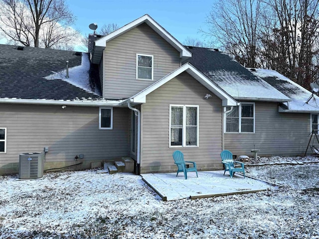 3020 10 Oclock Rd, Bloomingdale, IN 47832 - snow covered property with central AC unit, a patio, a shingled roof, and a chimney