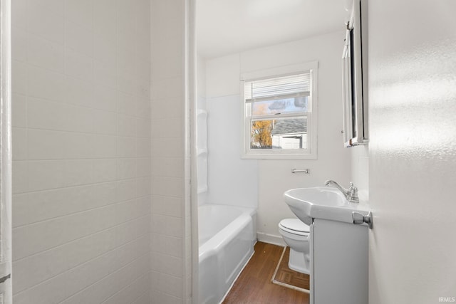 bathroom featuring vanity, wood-type flooring, and toilet