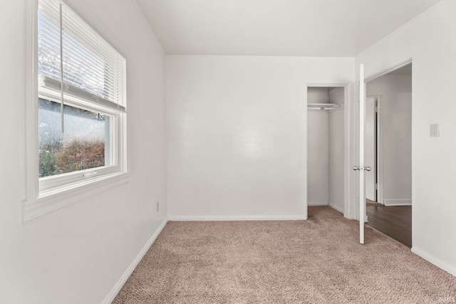 unfurnished bedroom with carpet floors and a closet