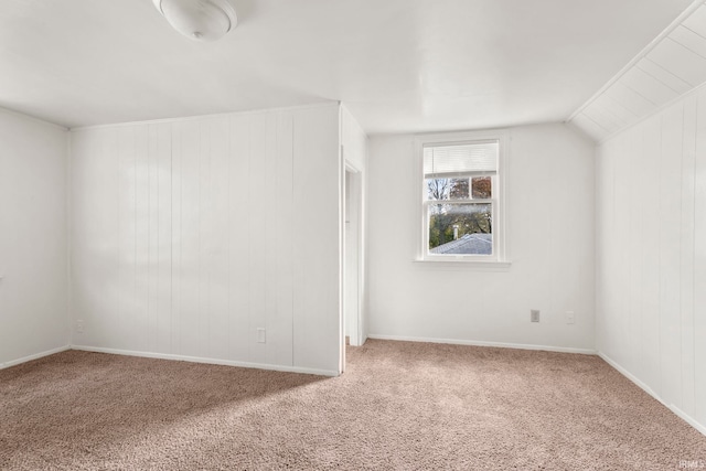 bonus room with lofted ceiling, carpet floors, and wooden walls