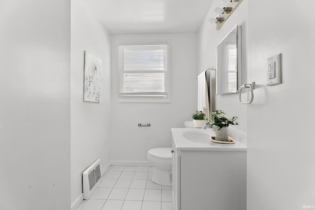 bathroom with toilet, vanity, and tile patterned floors