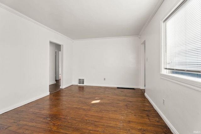 unfurnished room with ornamental molding and dark wood-type flooring