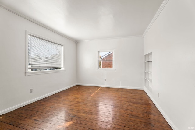 empty room with dark hardwood / wood-style flooring and ornamental molding