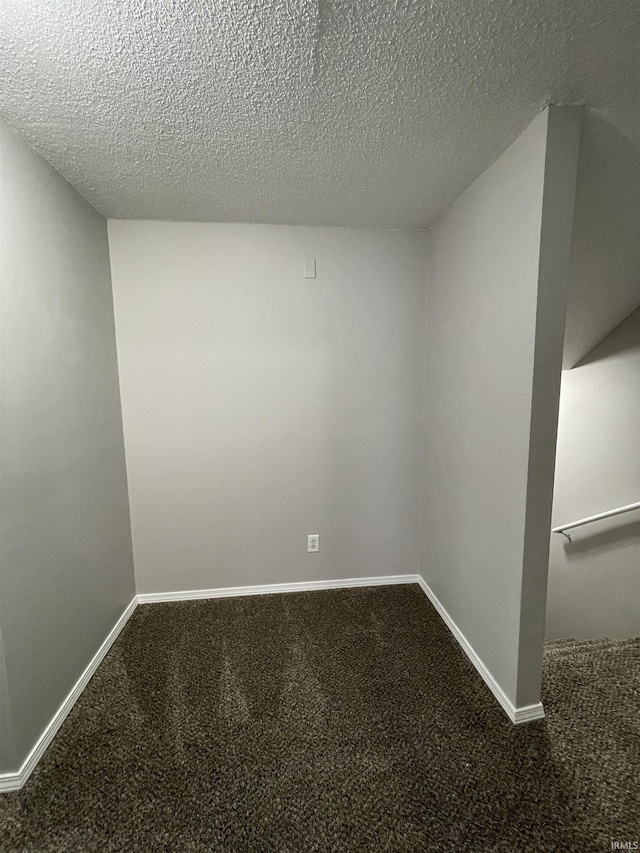 spare room featuring carpet floors and a textured ceiling