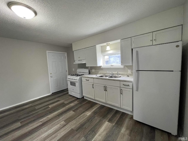 kitchen featuring white appliances, sink, dark hardwood / wood-style floors, a textured ceiling, and white cabinetry