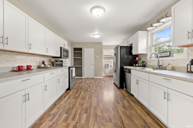 kitchen with decorative backsplash, stainless steel appliances, white cabinetry, and dark hardwood / wood-style floors