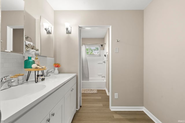 bathroom with tasteful backsplash, vanity, shower / tub combo, and hardwood / wood-style flooring