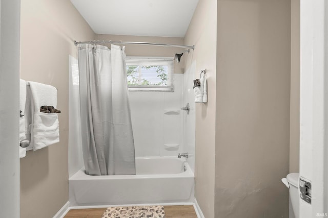 bathroom with shower / bath combination with curtain and wood-type flooring