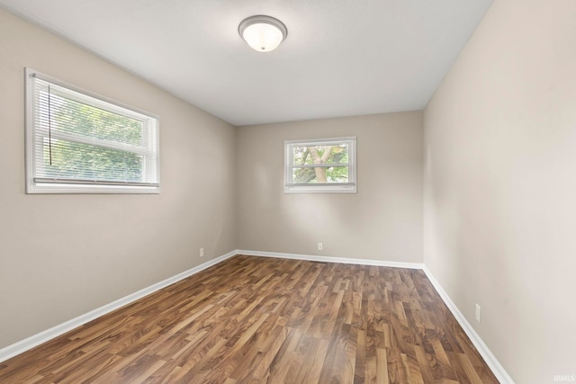 spare room featuring dark wood-type flooring