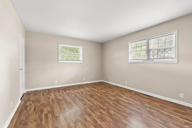 empty room featuring dark hardwood / wood-style flooring