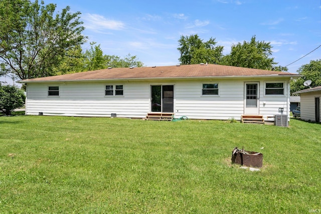 rear view of property with a yard