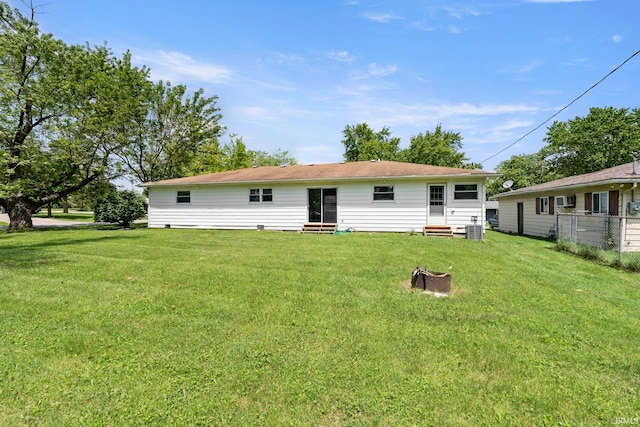 back of property featuring a lawn