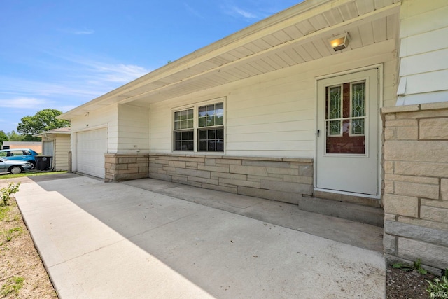 view of exterior entry with a garage