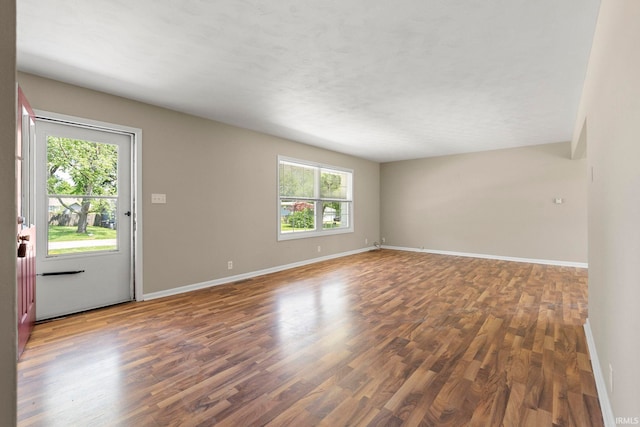 unfurnished room featuring dark wood-type flooring