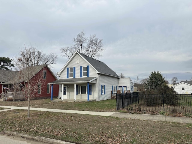 view of property featuring a porch and a front yard