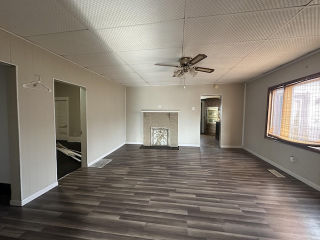 unfurnished living room with dark hardwood / wood-style floors and ceiling fan