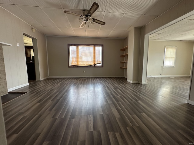 unfurnished living room with ceiling fan and dark hardwood / wood-style flooring