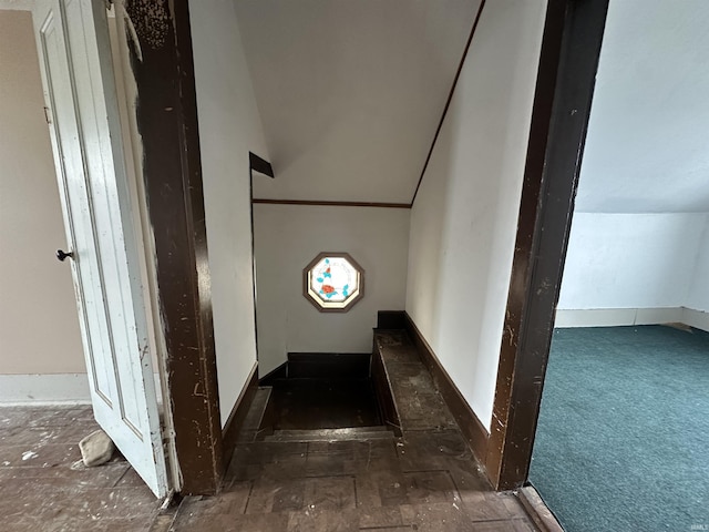 stairway with vaulted ceiling