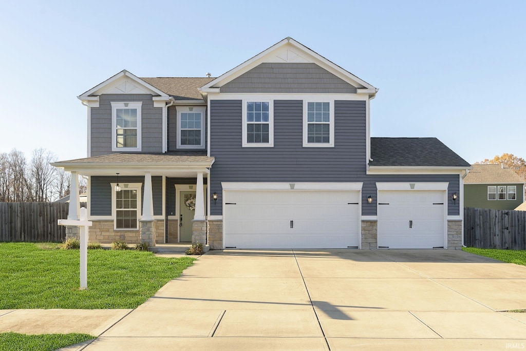 view of front facade featuring a garage and a front lawn