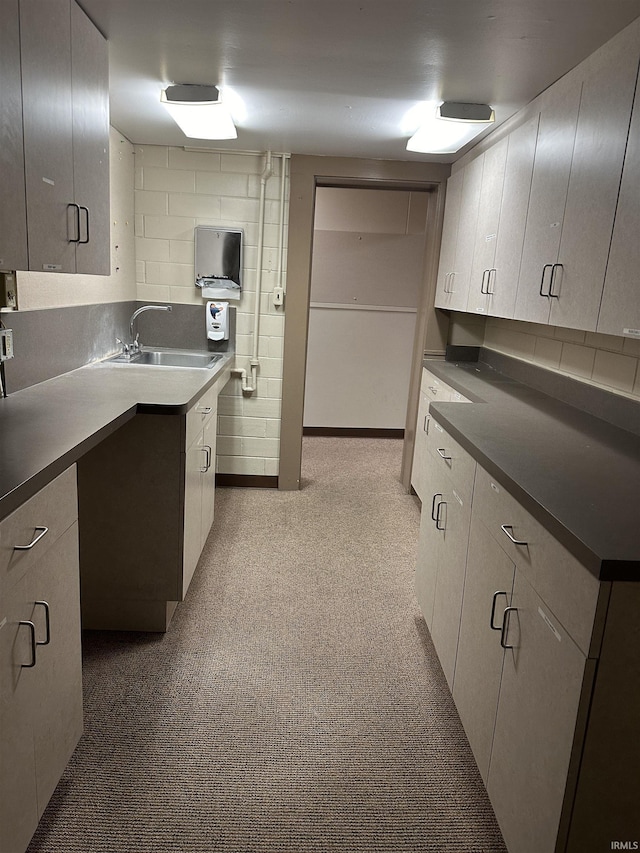 kitchen with tasteful backsplash, sink, and white cabinets