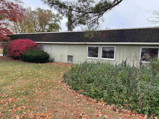 view of property exterior with a lawn