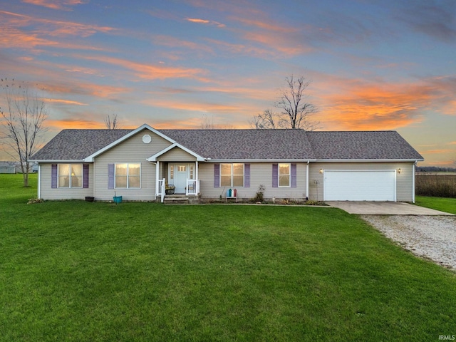 single story home with a garage and a yard