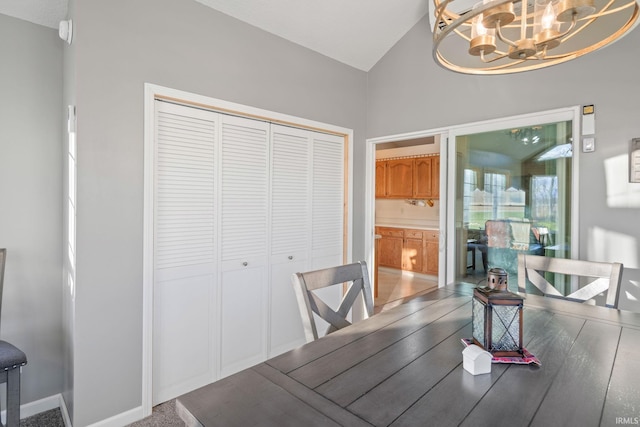 dining space featuring lofted ceiling and a chandelier