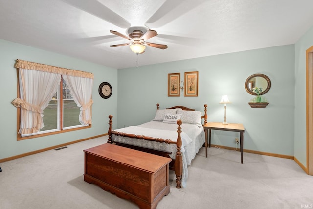 bedroom featuring ceiling fan and light colored carpet