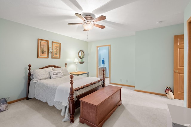 bedroom with connected bathroom, ceiling fan, and light carpet