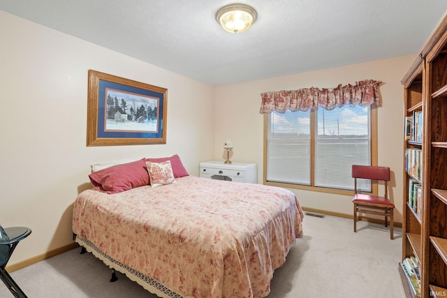 carpeted bedroom featuring a textured ceiling