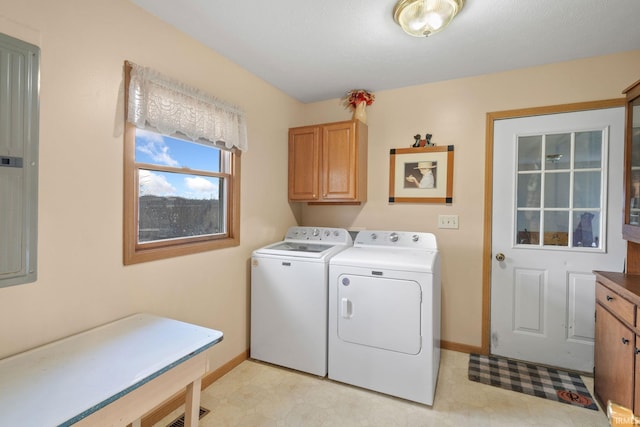 clothes washing area featuring washer and dryer and cabinets