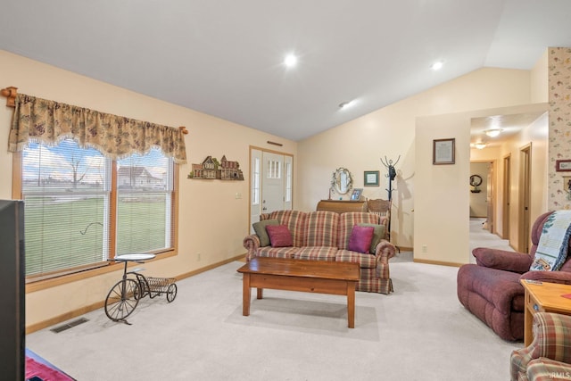 carpeted living room with vaulted ceiling