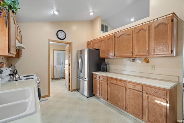 kitchen featuring stainless steel refrigerator with ice dispenser, stove, light colored carpet, sink, and lofted ceiling