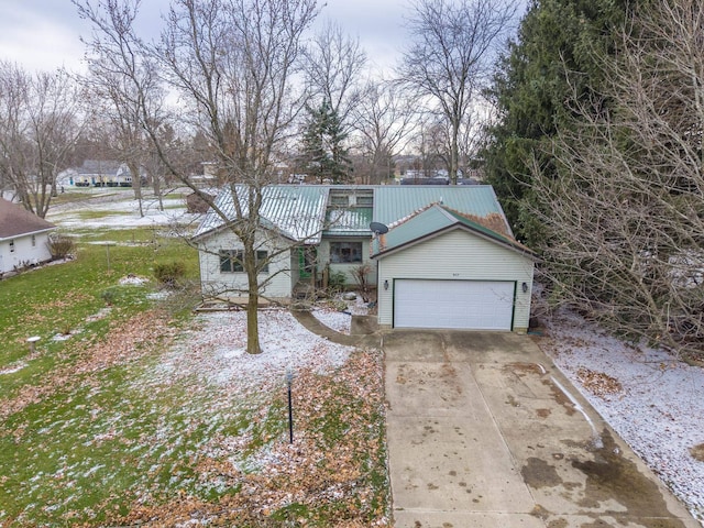 view of front of property with a garage and a front lawn