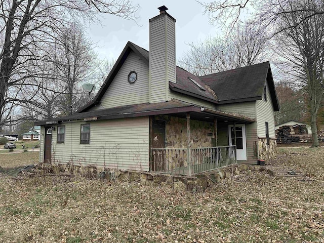 view of side of property with a porch