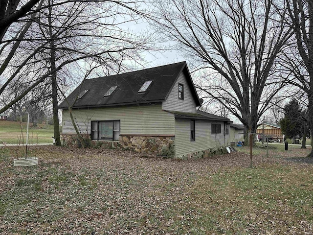 view of side of home featuring a lawn