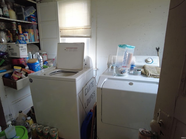 clothes washing area with separate washer and dryer