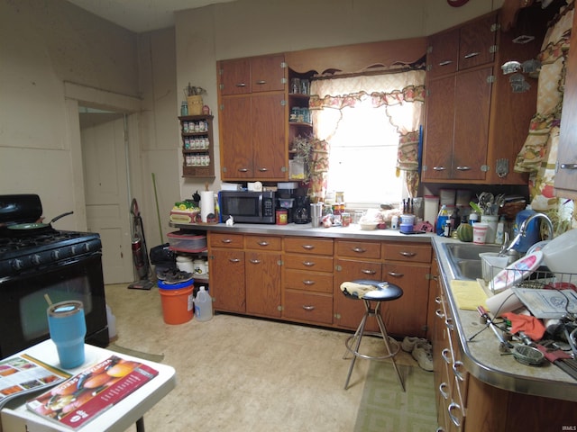 kitchen with black gas range and sink