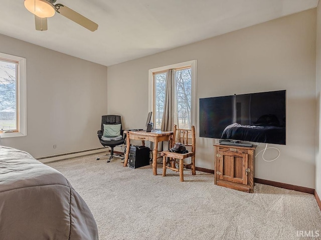 carpeted bedroom featuring baseboard heating and ceiling fan