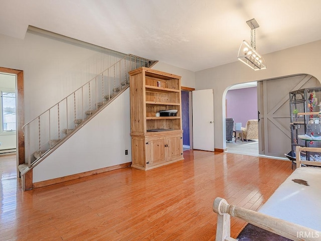 living room with a notable chandelier and light wood-type flooring