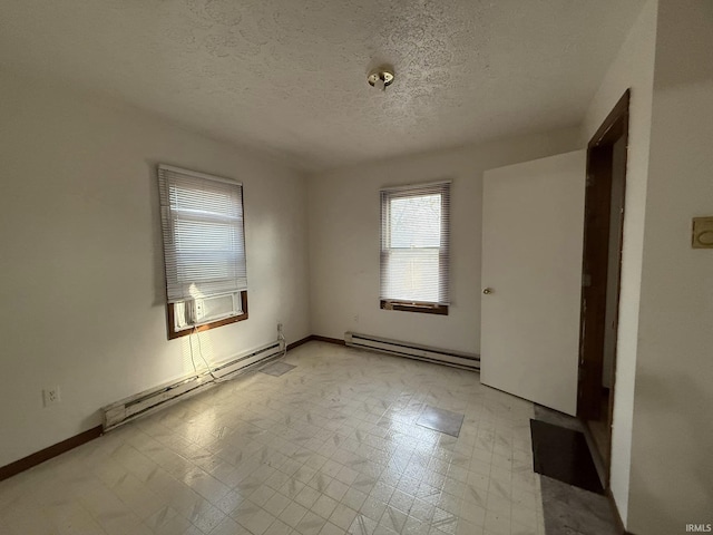 empty room featuring cooling unit, a baseboard radiator, and a textured ceiling