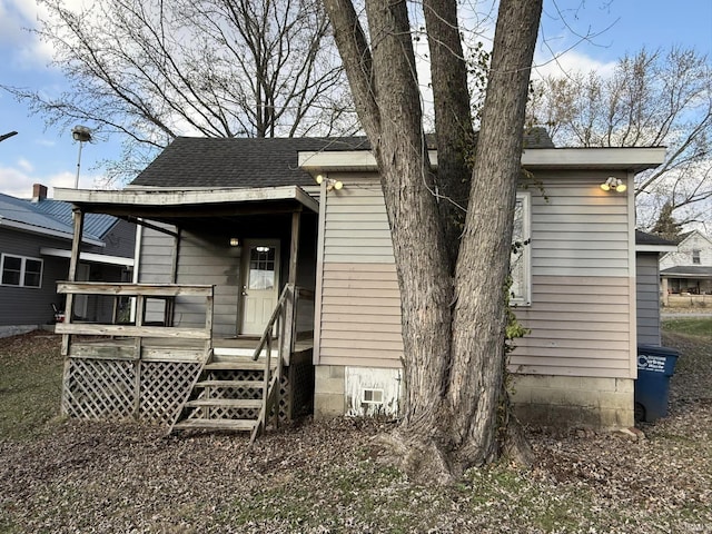 back of property with a wooden deck