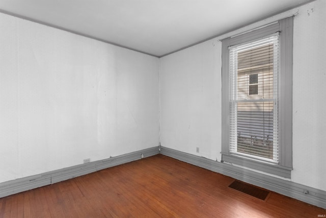 unfurnished room with wood-type flooring