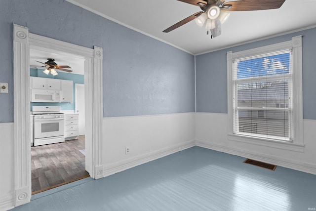 empty room with hardwood / wood-style floors and ornamental molding