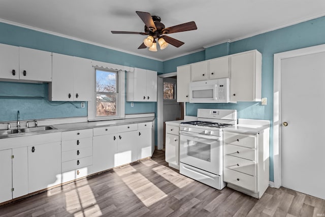 kitchen featuring light wood-type flooring, white appliances, white cabinetry, and sink