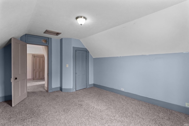 additional living space with light carpet and lofted ceiling