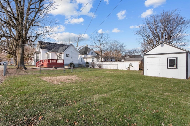 view of yard with a wooden deck and an outbuilding